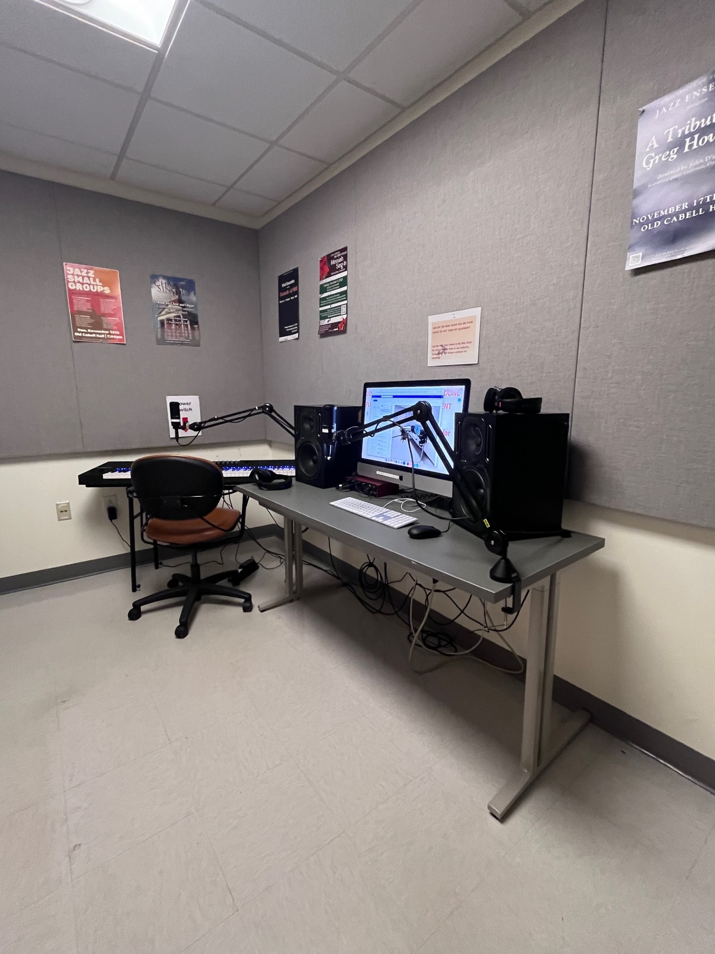 Photo of audio studio showing a computer and a piano keyboard