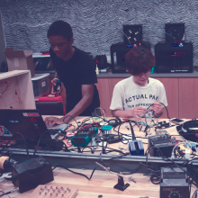 two students working with electronics